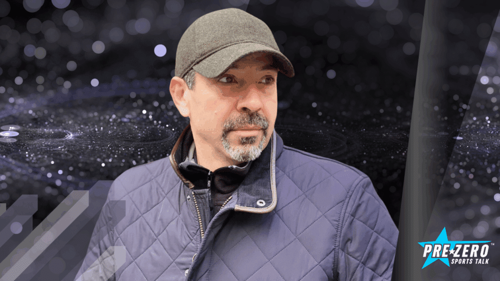Sid Bensalah, host of Pre-Zero Sports Talk Podcast, wearing a cap and jacket, looking forward. Purpose-driven podcast on sports, leadership, faith, innovation, and clean progress.