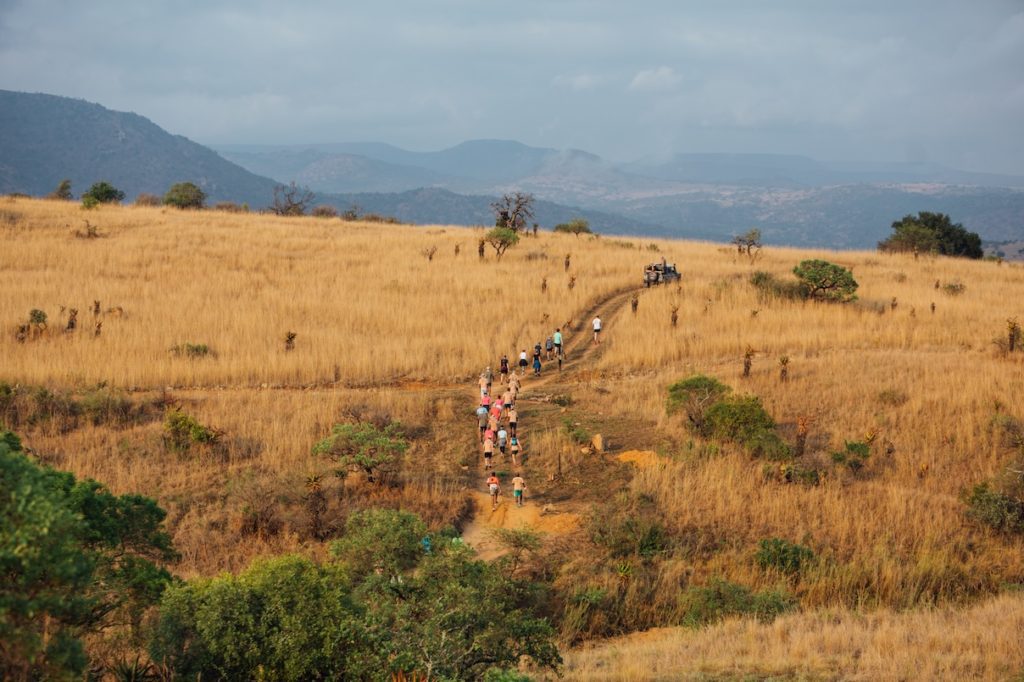 The participants are seen navigating through the beautiful yet challenging terrains, highlighting their commitment to the cause.