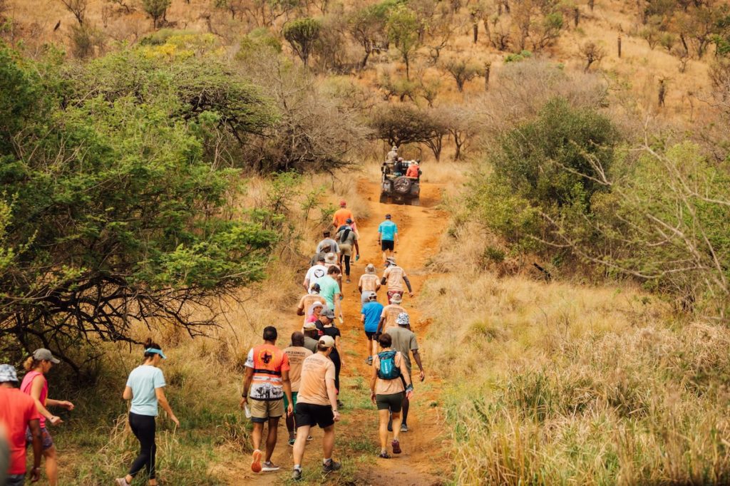 Participants are seen running through the scenic trails, emphasizing the dedication and endurance required for the event.