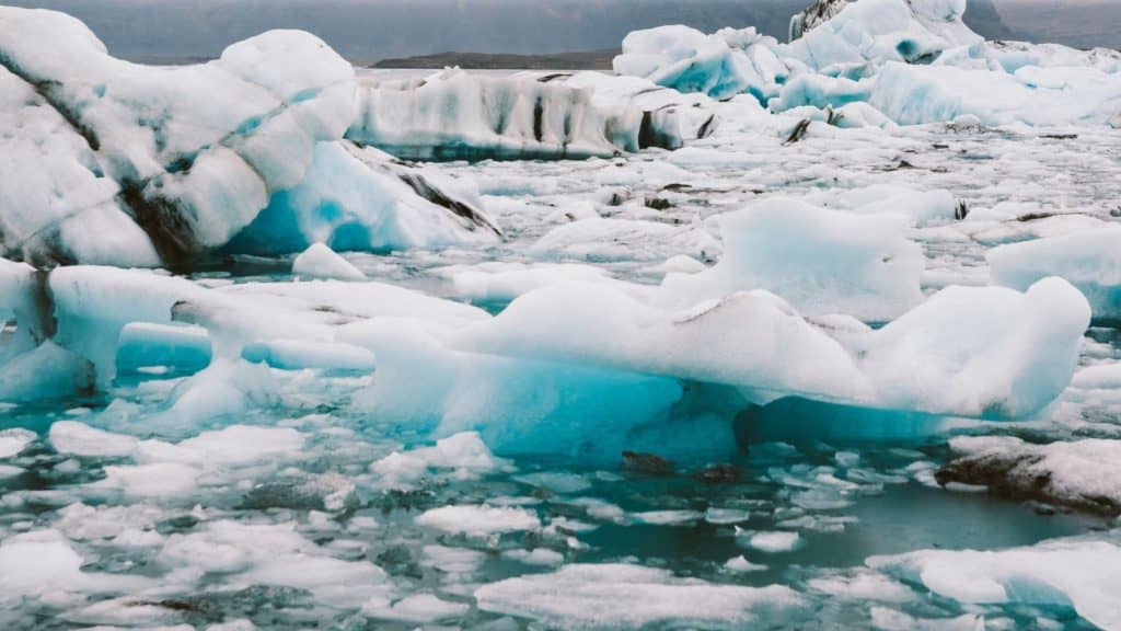 Melting glaciers and broken icebergs in the Arctic region.