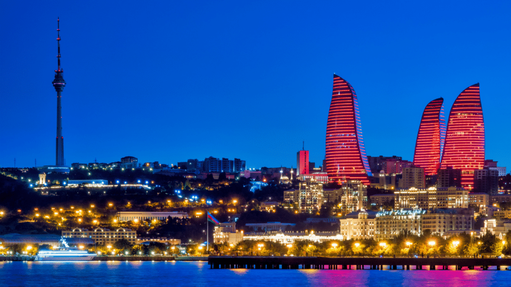 Baku skyline at night featuring the Flame Towers illuminated in red, site of COP29 in 2024.